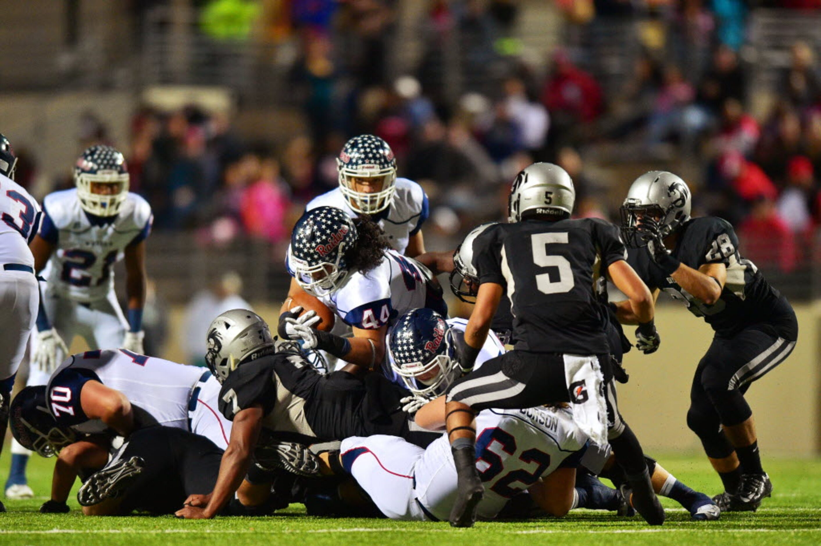 Ryan senior defensive tackle Mario Caballero (44) comes in on offense and takes the ball up...