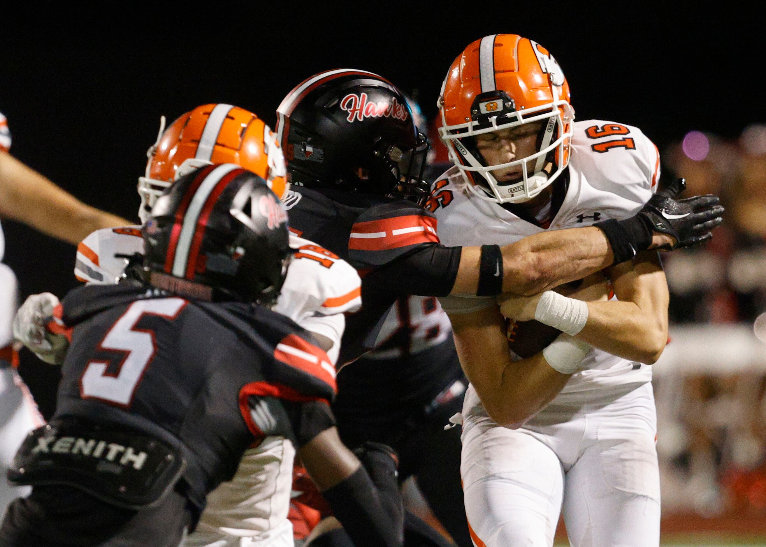 Rockwall's quarterback Mason Marshall (16) keeps a ball away from Rockwall-Heath's Chase...