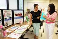 Kathie Vo, left, and Frances Leung go over some of the items used for the Asian Breast...