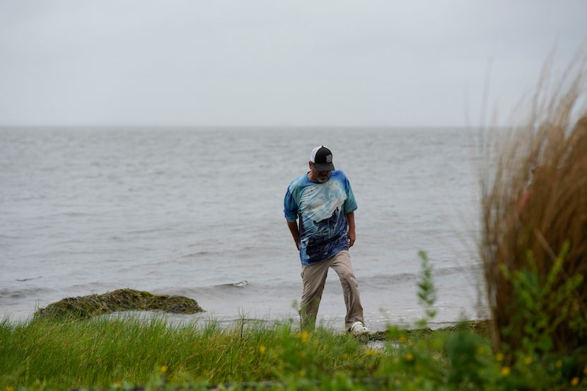 Bob Danzey, a resident, walked at the waters edge in Shell Point Beach, Fla., ahead of...