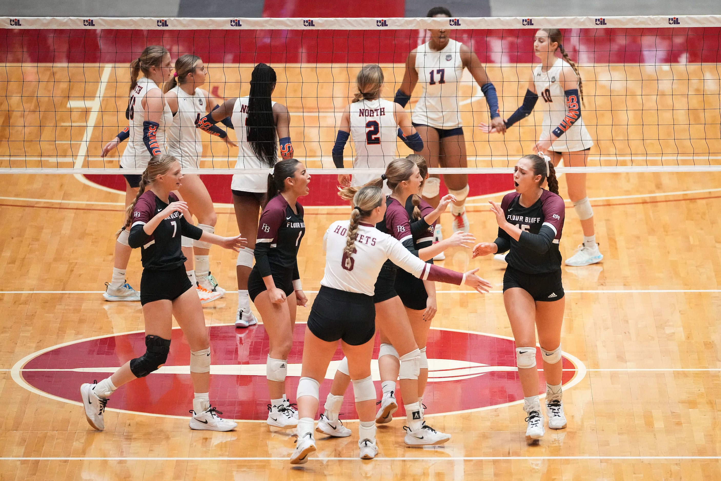 Corpus Christi Flour Bluff's Margaret Croft (15) celebrates with teammates before set point...