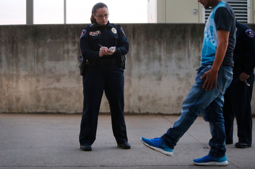 DWI police officer Stacie Brown does a sobriety test on a man arrested for a DWI at the...