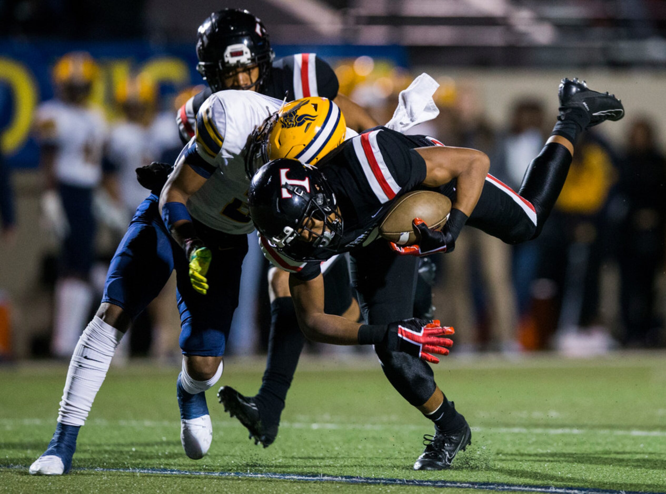 Euless Trinity running back Braxton Thomas (2) is tackled by Arlington Lamar running back...