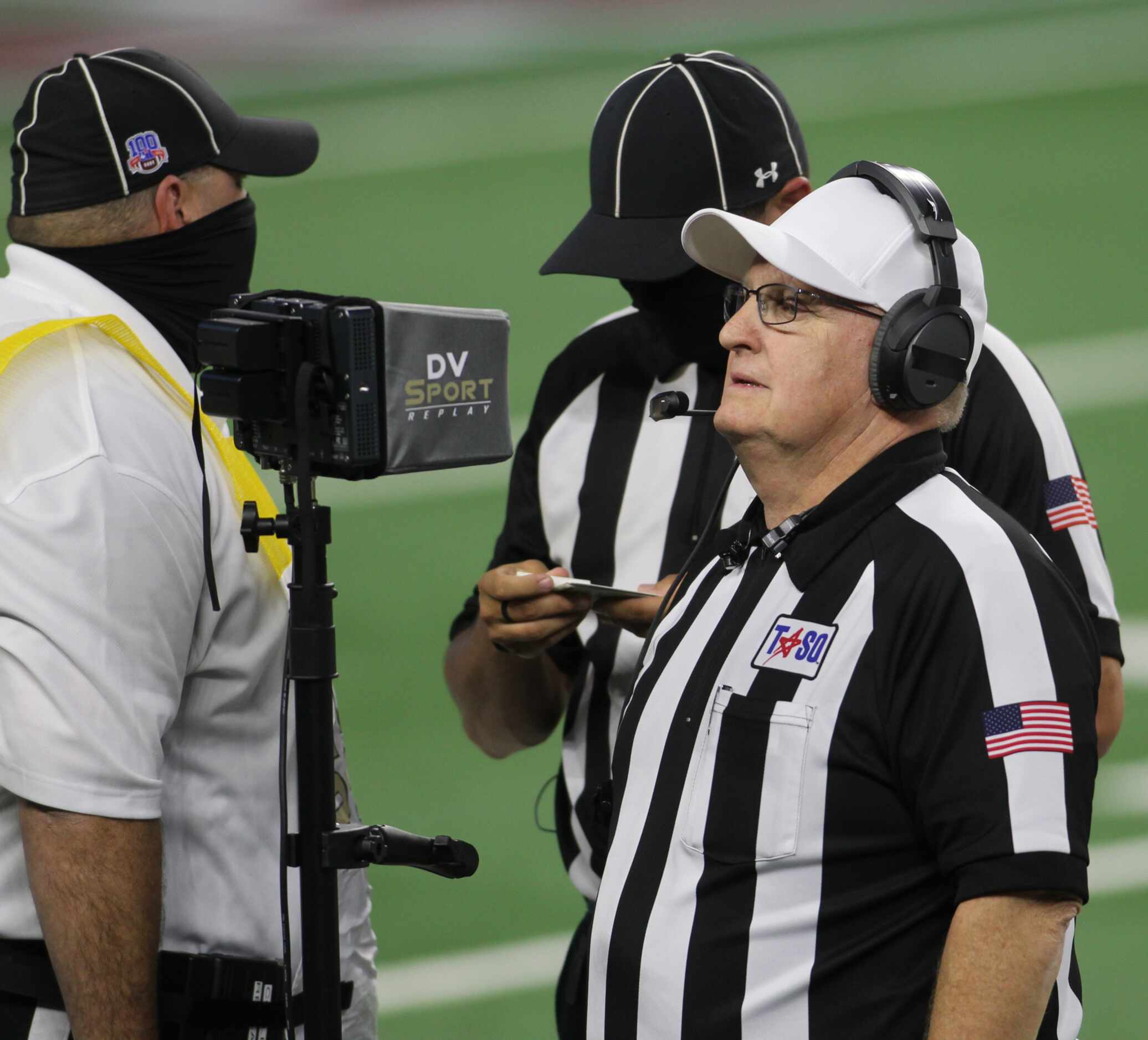 Game officials stop action to check instant replay following a first half scoring play in...