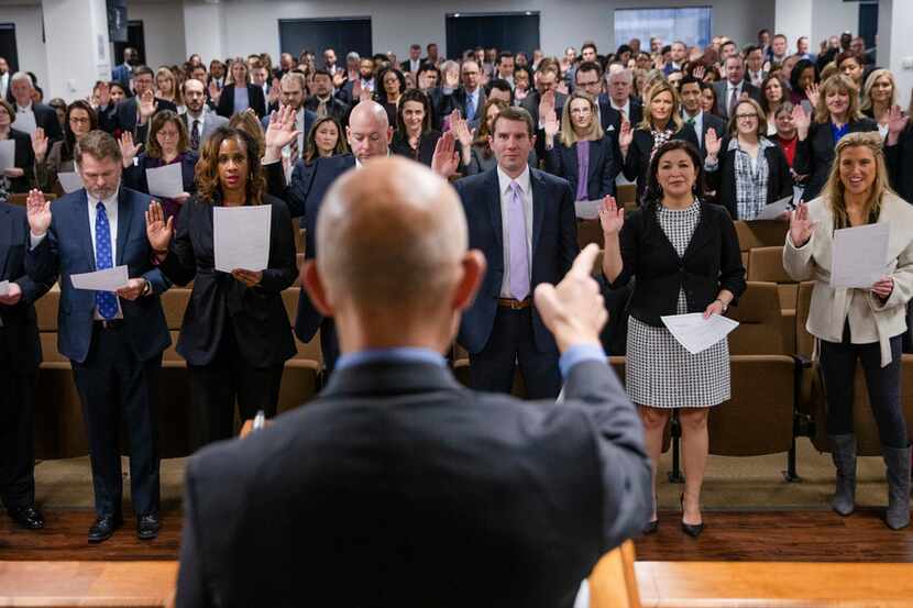District Attorney John Creuzot administers the oath of office to his prosecutors during a...