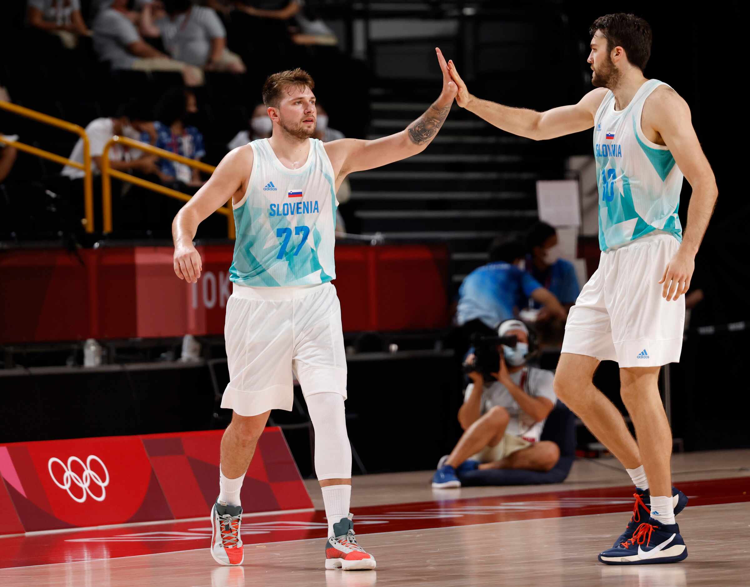 Slovenia’s Luka Doncic (77) and Mike Tobey (10) celebrate after a made basket against Japan...