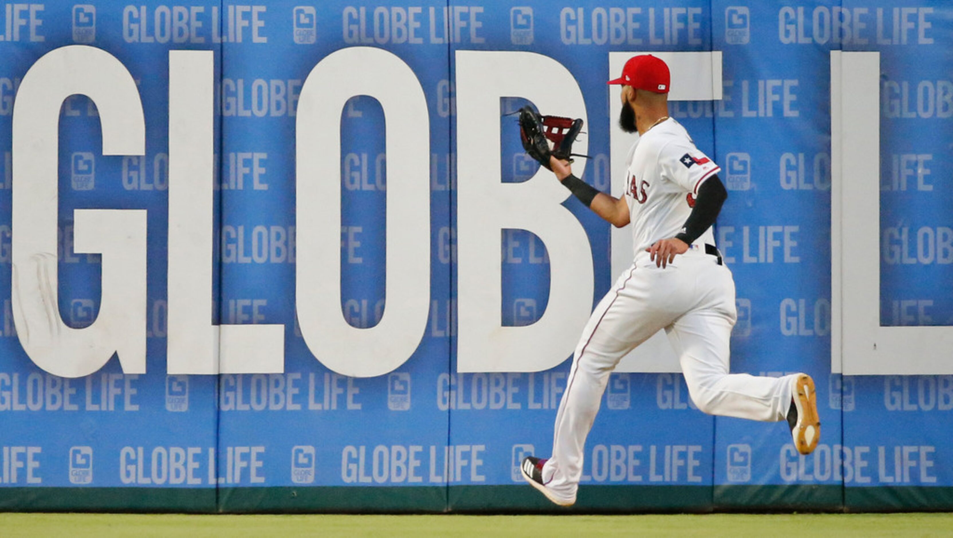 Texas Rangers right fielder Nomar Mazara (30) hauls in a long fly by Houston Astros Yuli...