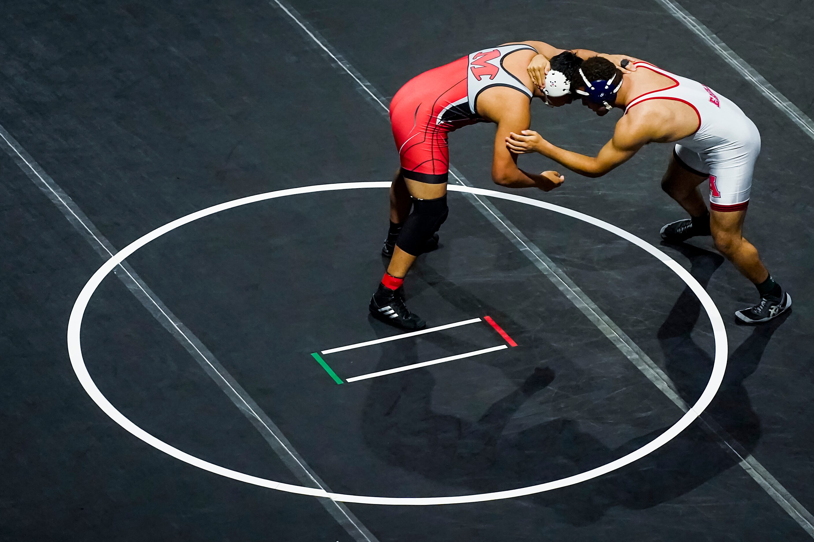 Maxwell Soto of Arlington Martin (left) wrestles Isaiah Steel of Allen for the 6A boys...