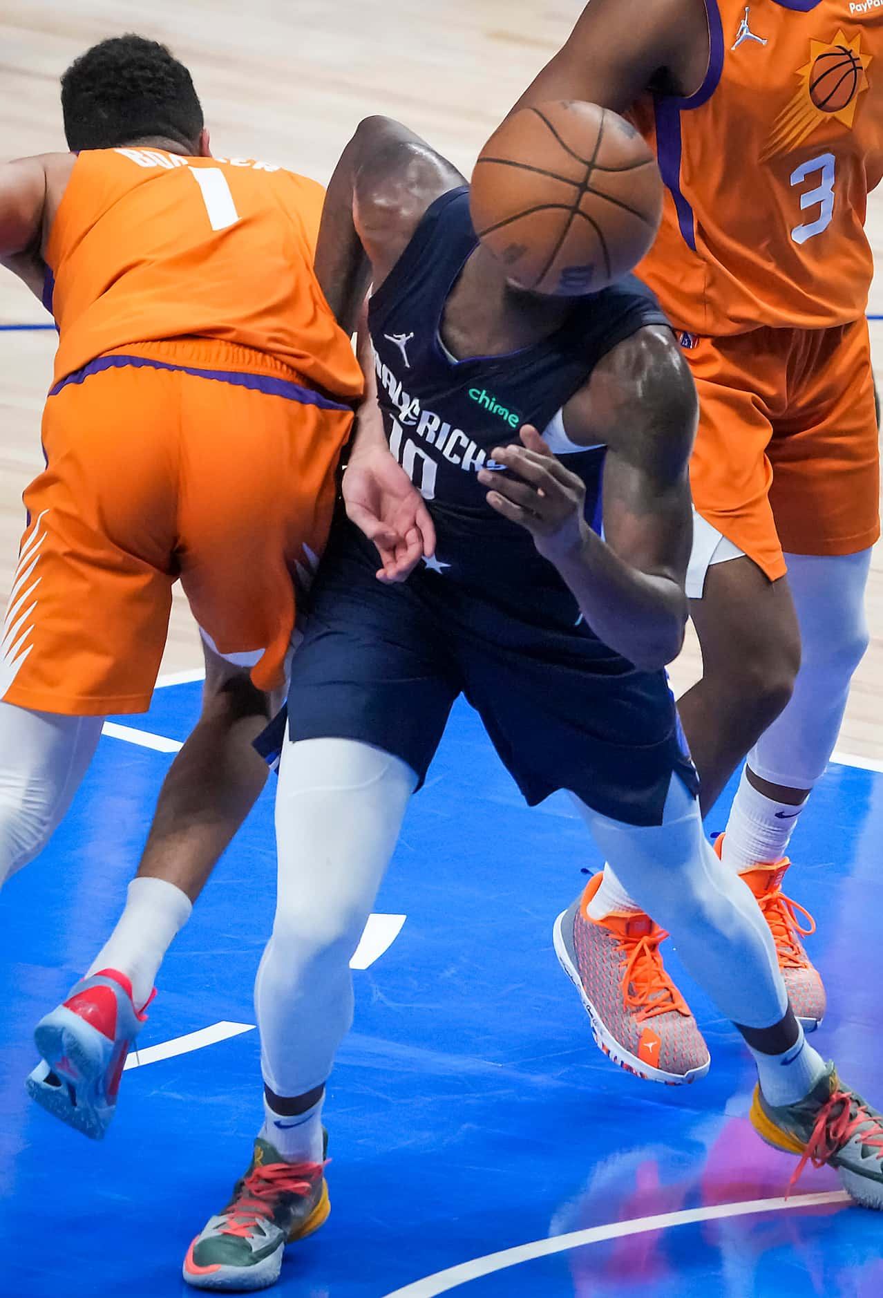 Dallas Mavericks forward Dorian Finney-Smith (10) fights for a rebound against Phoenix Suns...