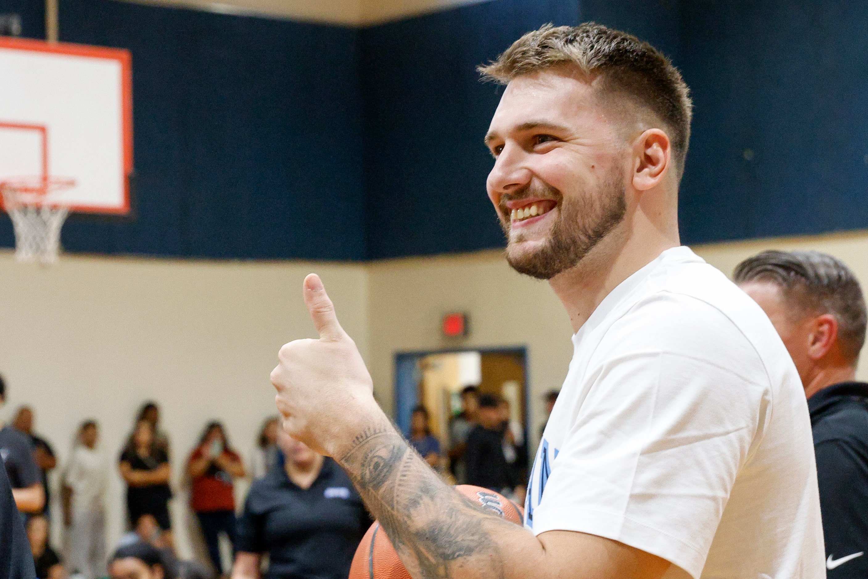 Dallas Mavericks guard Luka Doncic gives a thumbs up to a camera during a children’s...