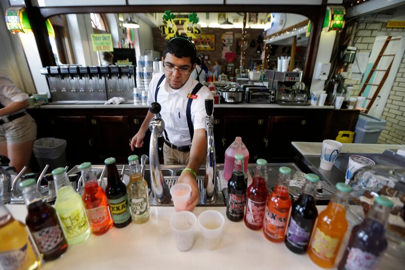 In this June 14, 2014 photo, Jimmy Aguilar serves a soda at the Dublin Bottling Co. in...