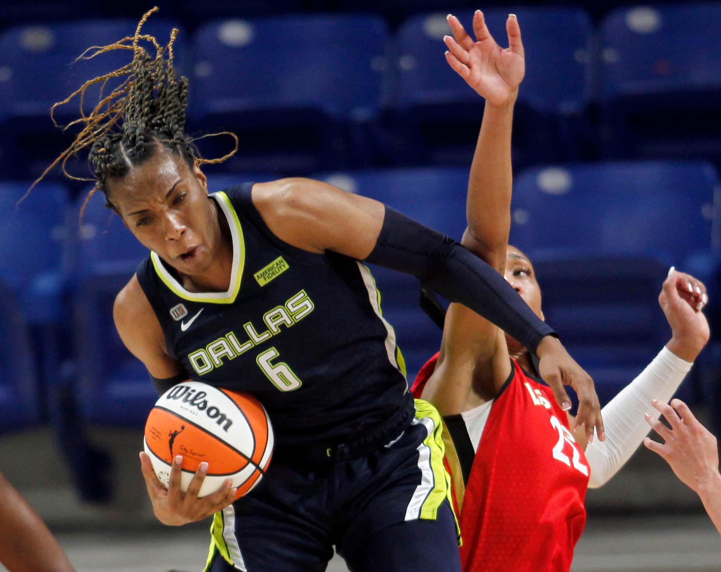 Dallas Wings forward Kayla Thornton (6) comes down with a rebound as she is challenged by...