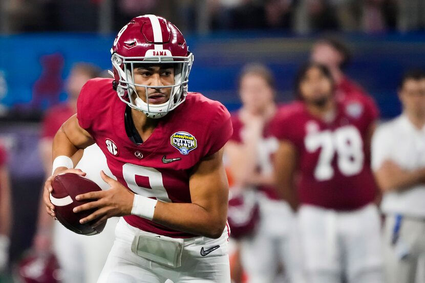 Alabama quarterback Bryce Young (9) scrambles from the pocket during the first half of the...