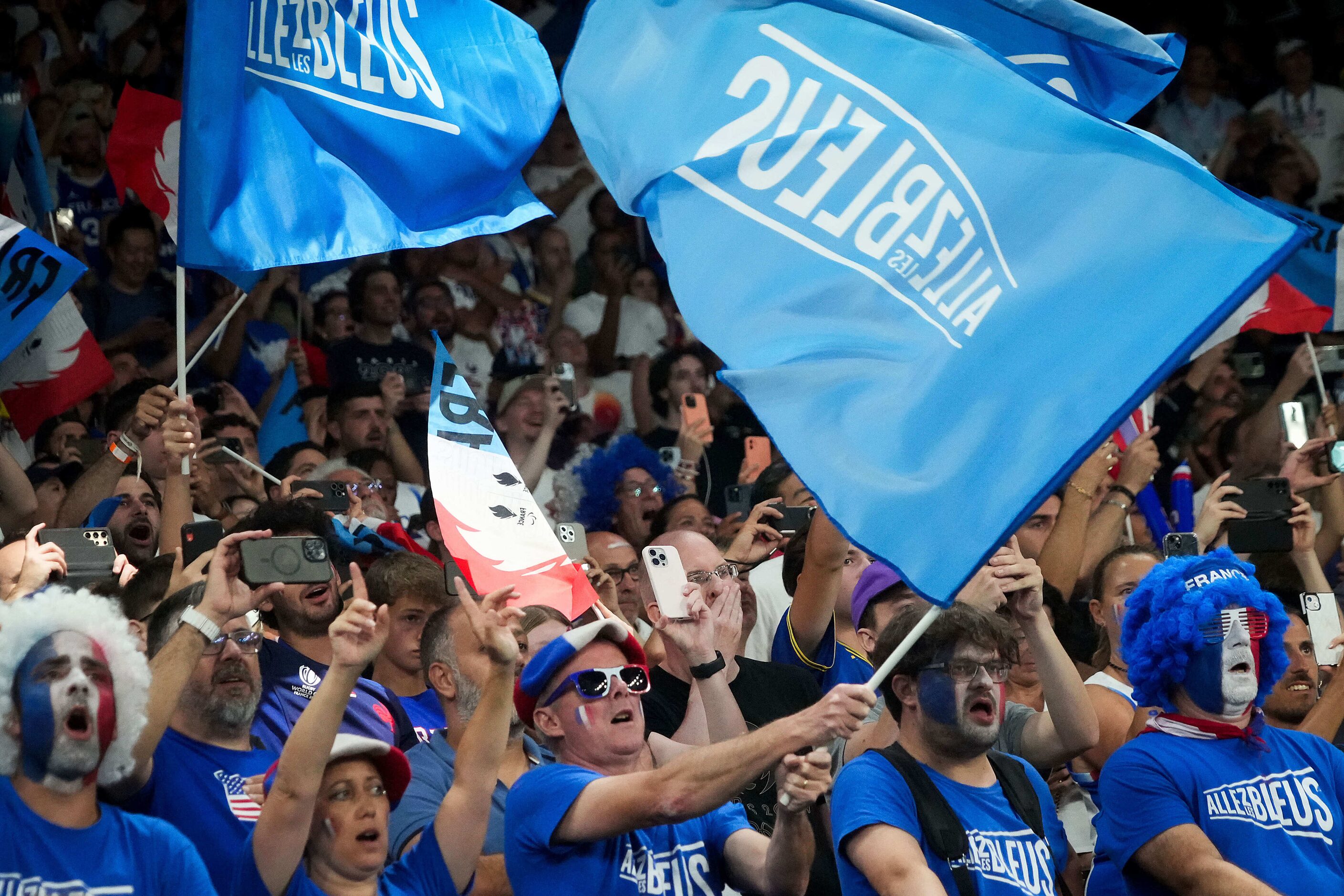 Fans cheer for France before the men's gold medal basketball game against the United States...