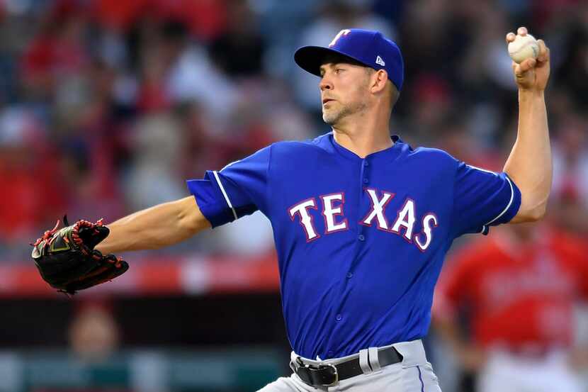 ANAHEIM, CA - AUGUST 27: Mike Minor #23 of the Texas Rangers pitches in the first inning...