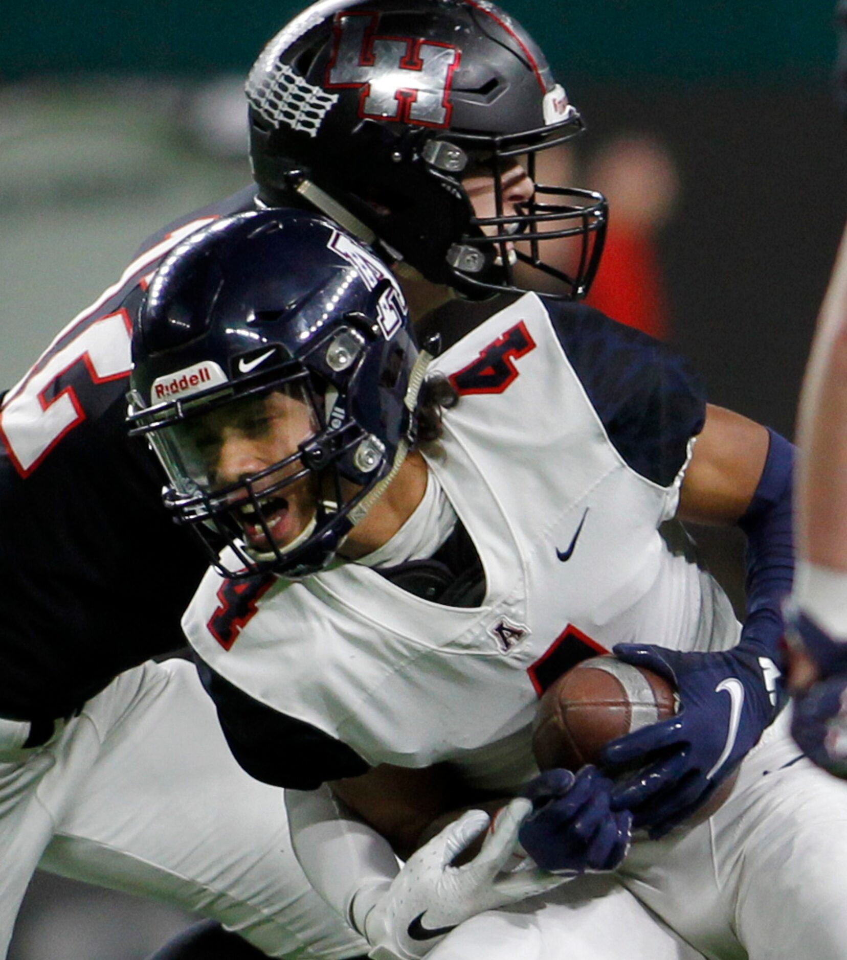 Allen receiver Jordyn Tyson (4) pulls in a long pass despite the defense of Lake Highlands...