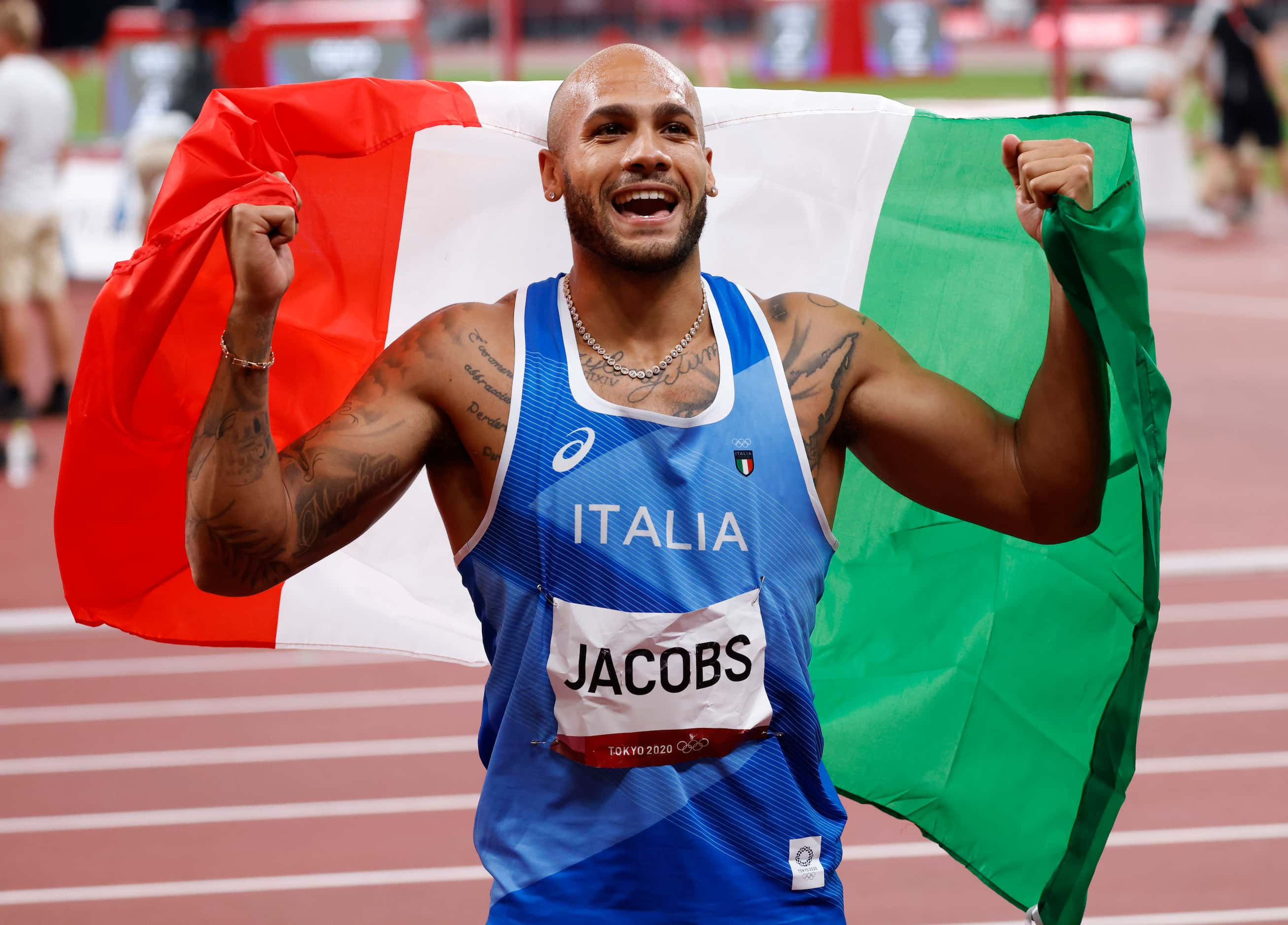 Italy’s Lamont Marcell Jacobs celebrates after competing in the men’s 100 meter final during...