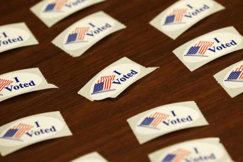 Stickers await early voters at a library in Davenport, Iowa. The state has a measure on the...