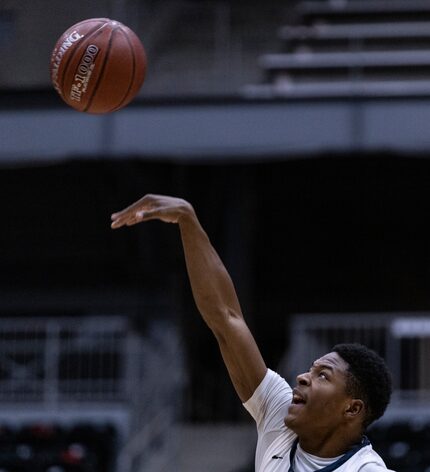 Justin F. Kimball High School Tray Clayton (10) jumps for the ball at the beginning of the...