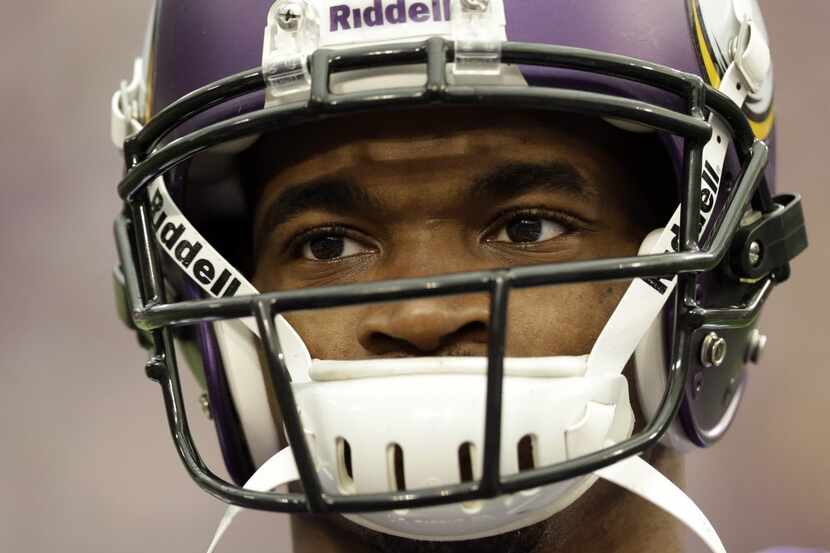 Minnesota Vikings running back Adrian Peterson pauses during introductions before an NFL...
