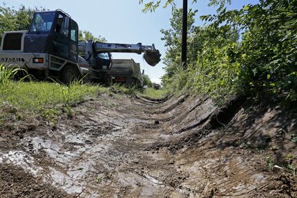 Commissioner John Wiley Price's Road and Bridge District 3 crews work on a drainage ditch...