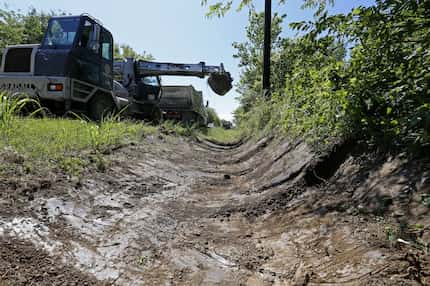 Commissioner John Wiley Price's Road and Bridge District 3 crews work on a drainage ditch...