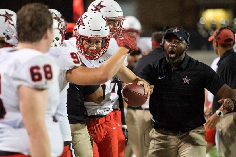 Coppell's Caden Davis (16) is congratulated by teammates after running for a first down on a...