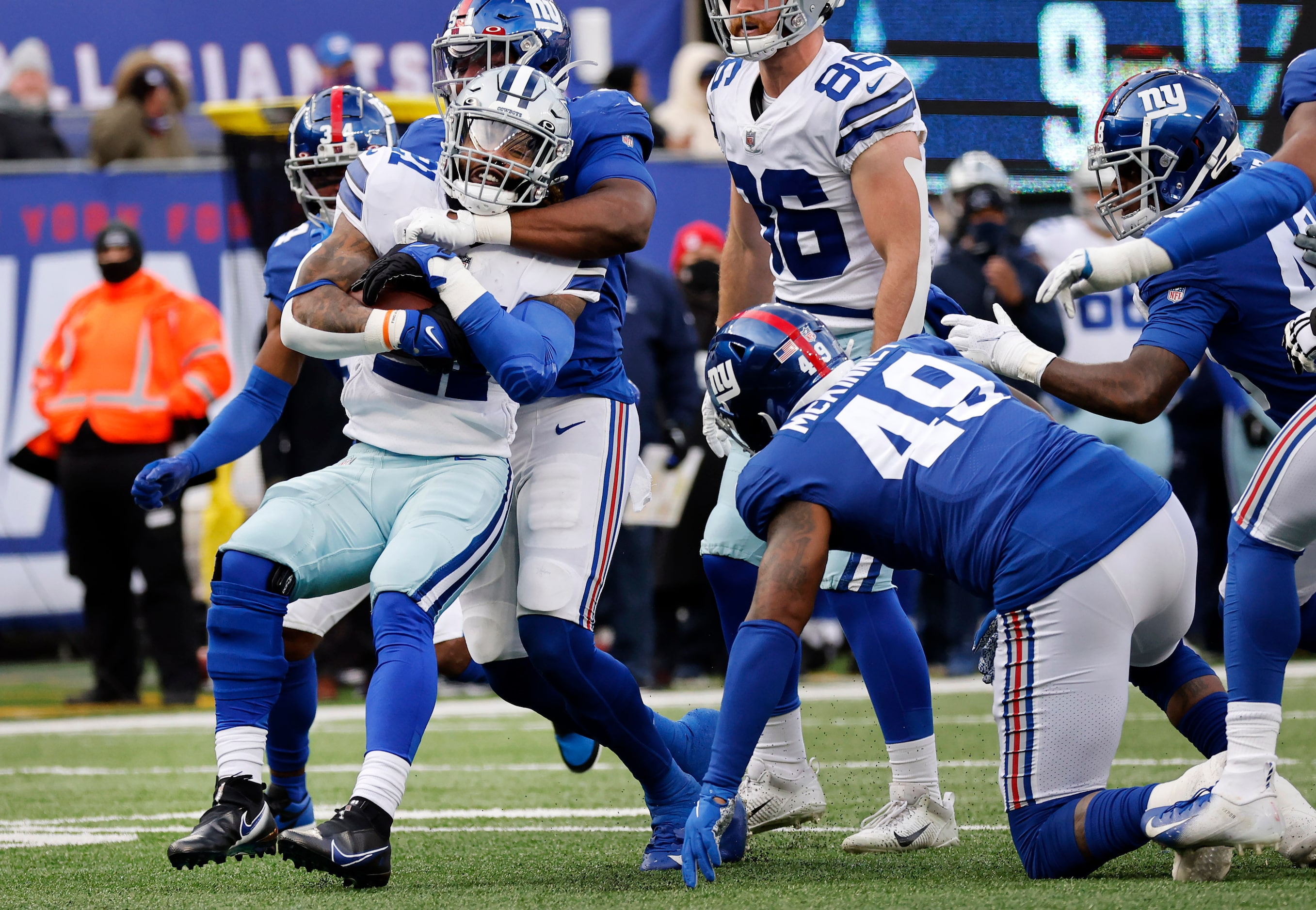 Dallas Cowboys running back Ezekiel Elliott (21) is pushed back after running into New York...