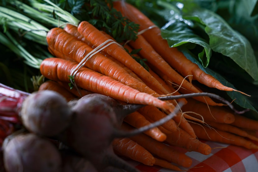 Beets and carrots for sale at the Williams Garden booth in The Shed at the Dallas Farmers...