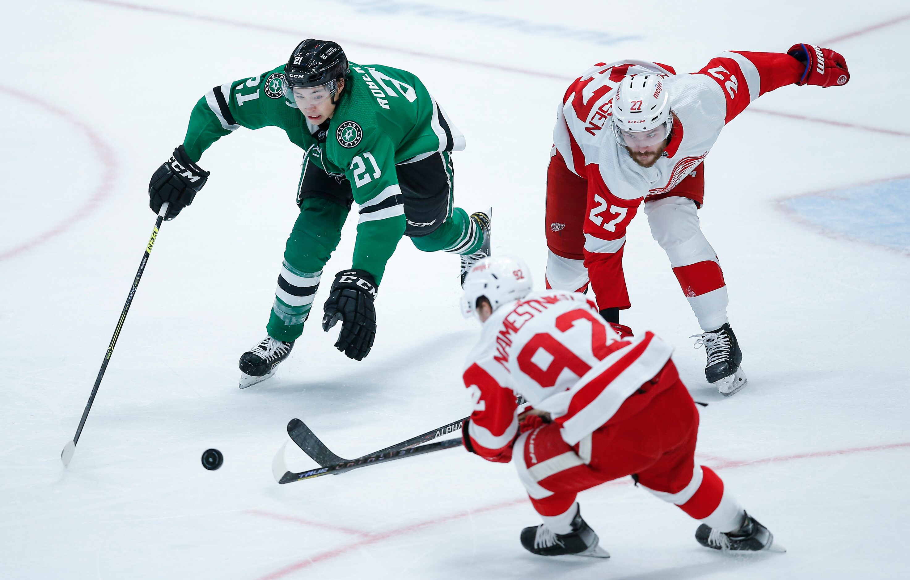 Dallas Stars forward Jason Robertson (21) battles Detroit Red Wings forwards Vladislav...