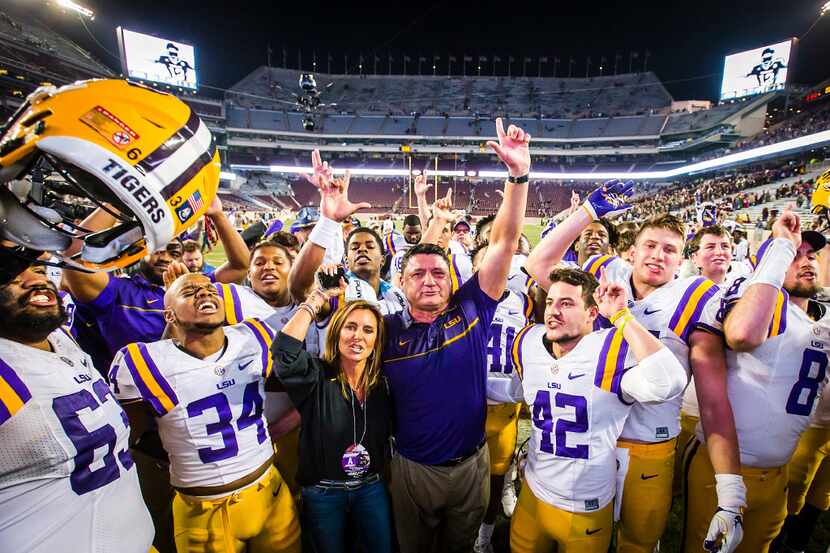 LSU head coach Ed Orgeron celebrates with his players after a win over Texas A&M in an NCAA...