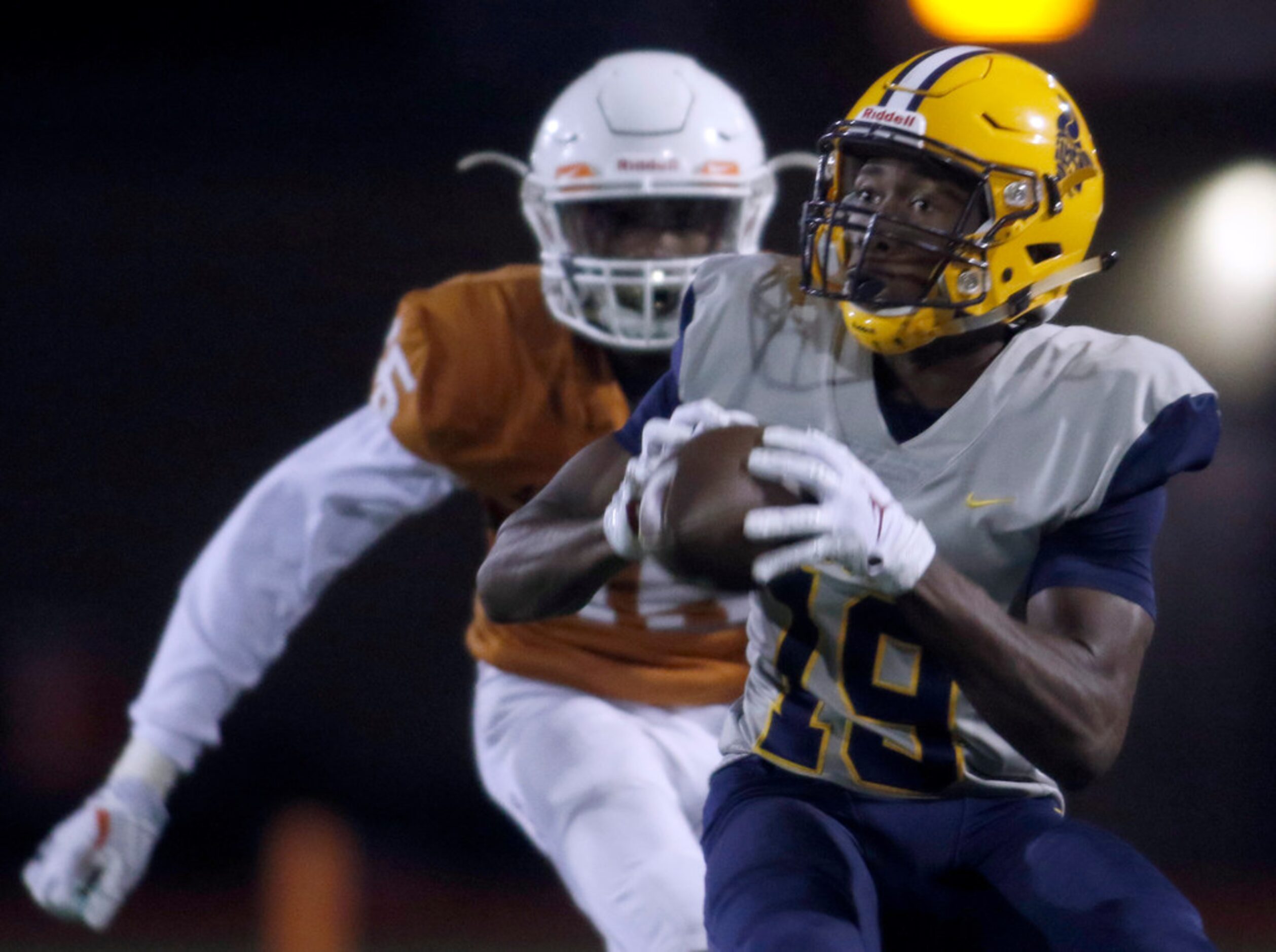 Arlington Lamar receiver Trevor West (19) pulls in a reception in front of Arlington Bowie...