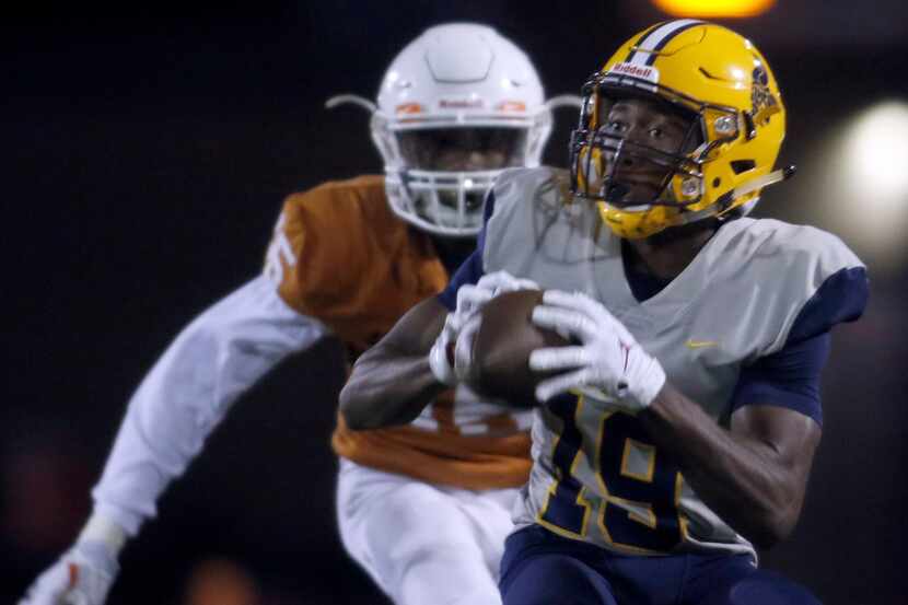 Arlington Lamar receiver Trevon West (19) pulls in a pass in front of Arlington Bowie...