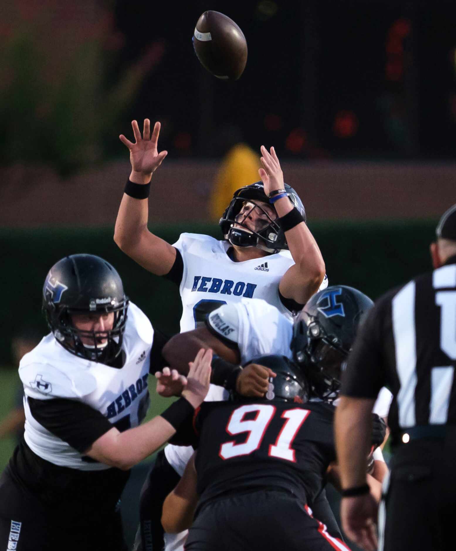 Hebron quarterback  Caron Harris (8) kreaches for a high snap during the first half of a...