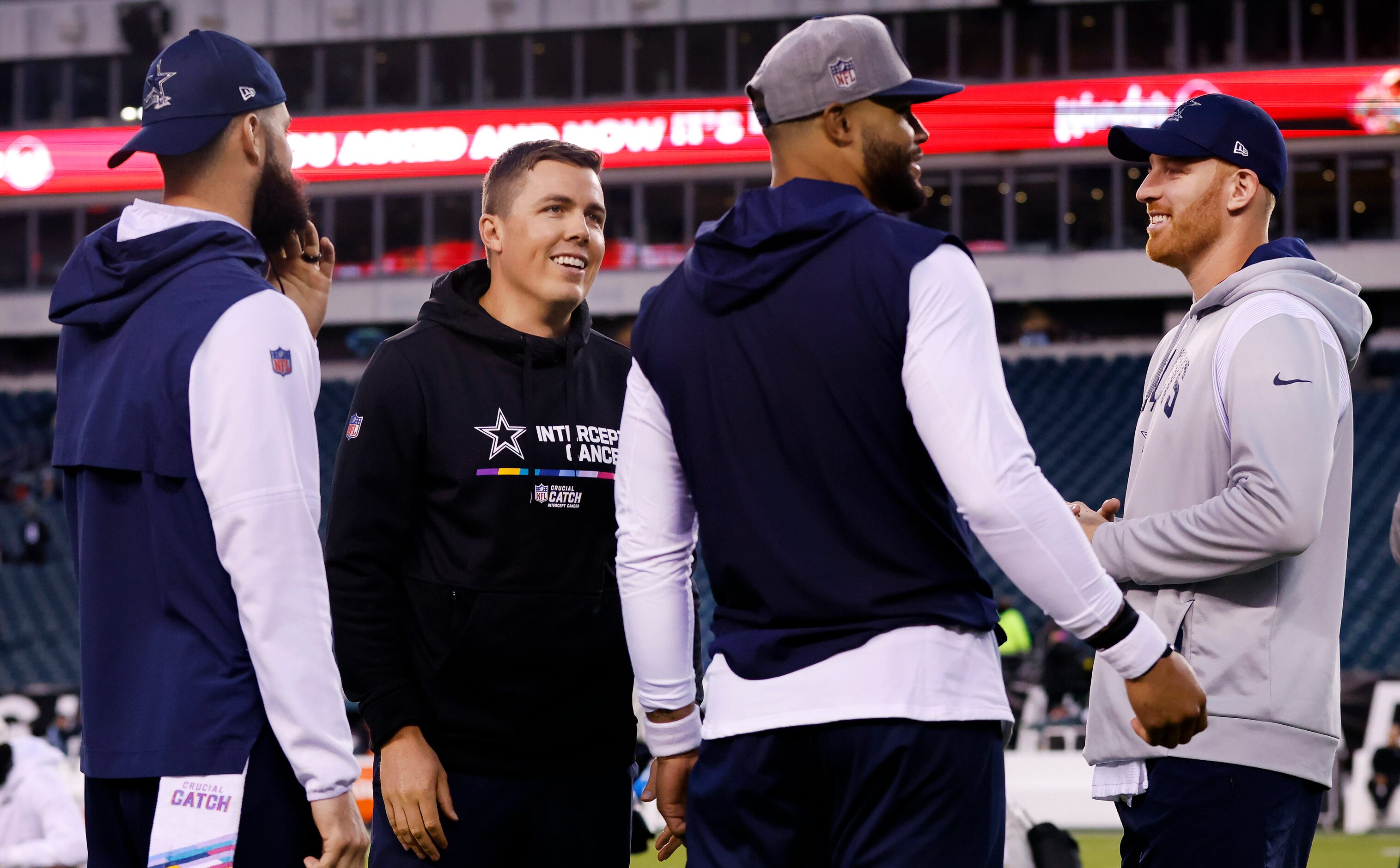 Dallas Cowboys offensive coordinator Kellne Moore (second from left) visits with...