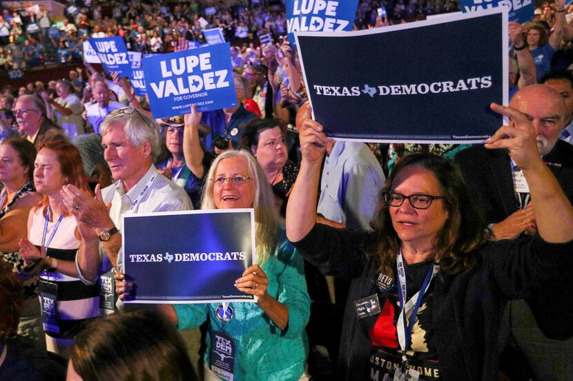 Attendees cheer and wave signs during the speech by Texas gubernatorial candidate Lupe...