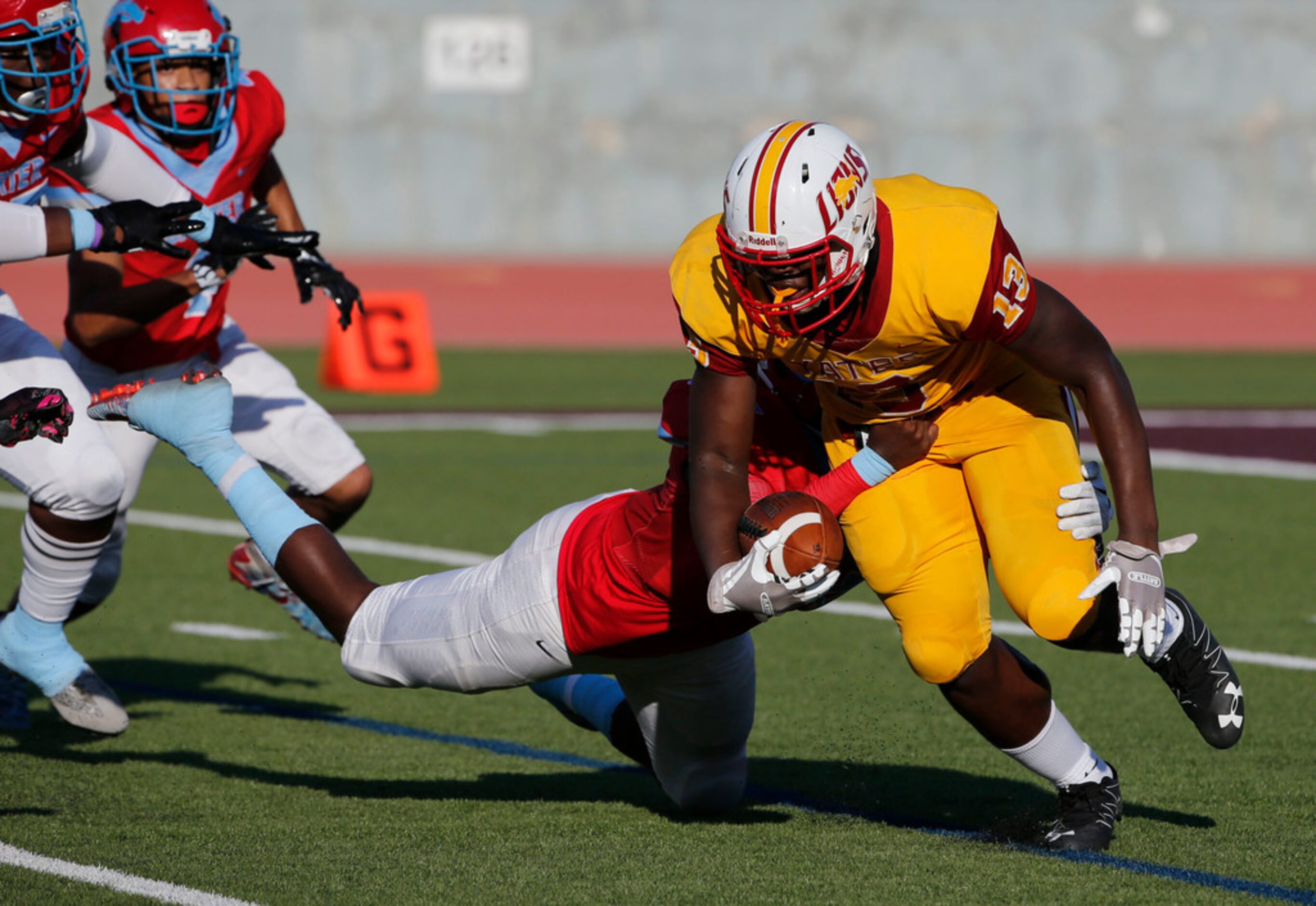 Dallas Carter defender Randy Anthony (54) tackles Houston Yates quarterback Keyshawn  Fields...