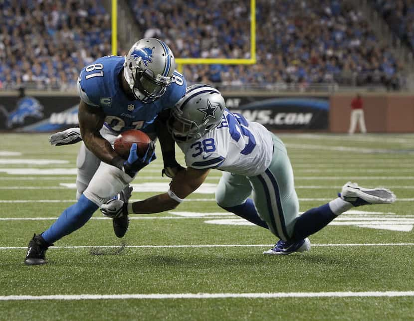 Dallas Cowboys defensive back Jeff Heath (38) stops Detroit Lions wide receiver Calvin...