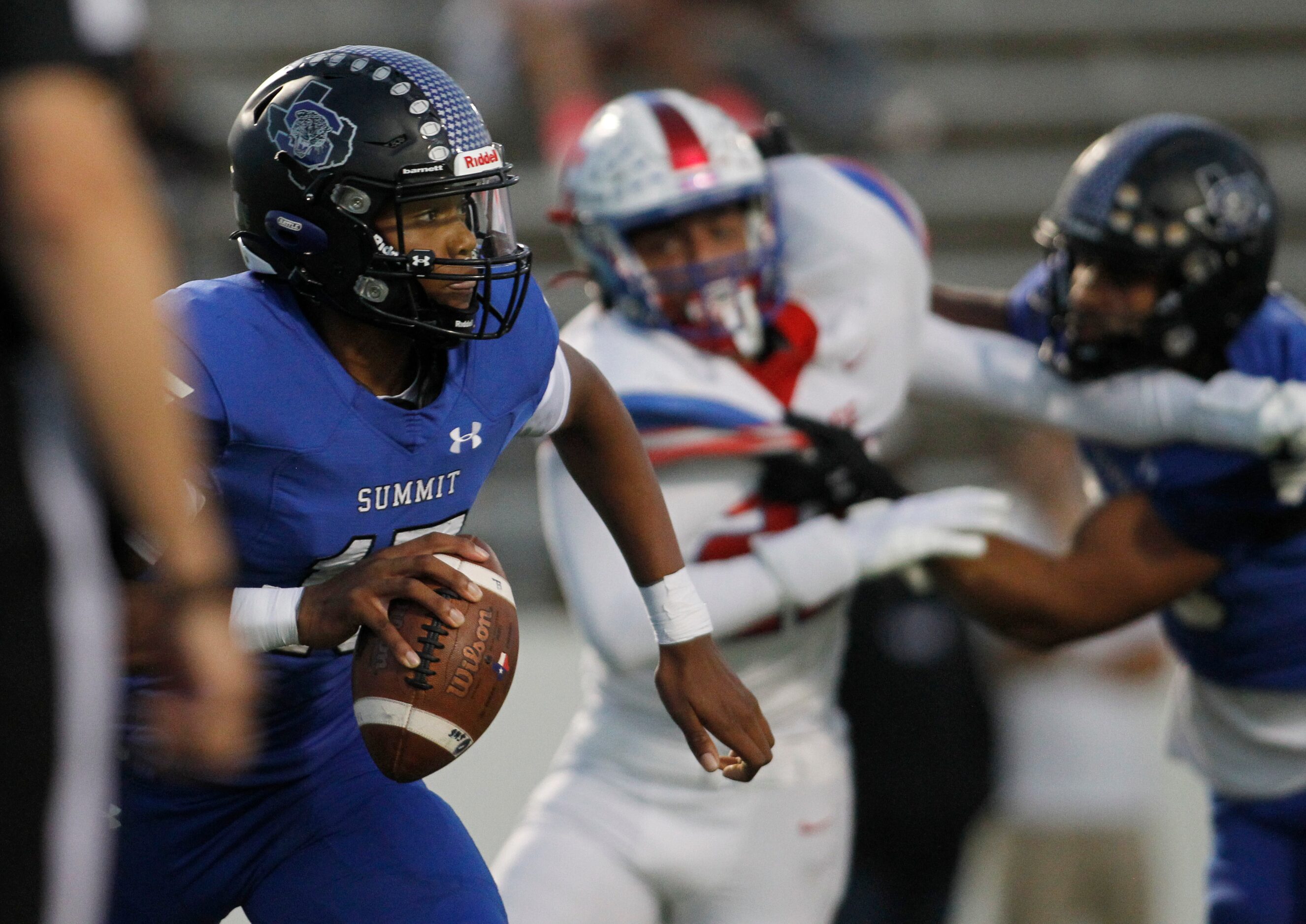 Mansfield Summit quarterback Demarus Bird (15) rolls out in search of a receiver during...