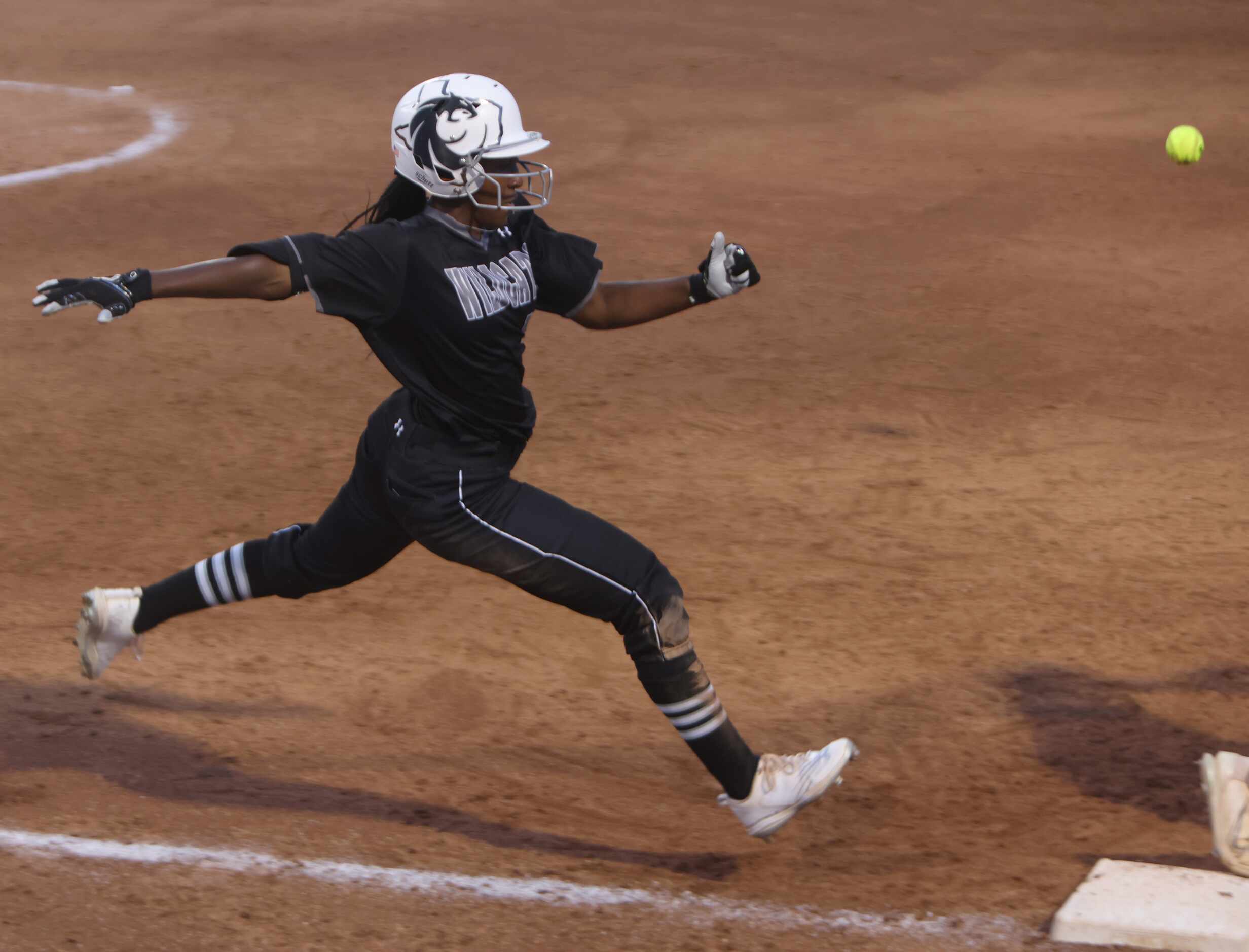 Denton Guyer outfielder Briana Williams (13) sprints down the baseline to beat out the throw...