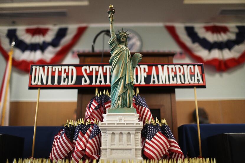 A model of the Statue of Liberty adorns a podium at a naturalization ceremony. (Joe...