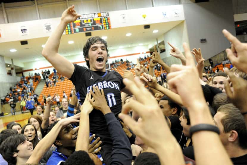 Hebron's Ridge Shipley celebrates with fans on the court after their 62-55 win over DeSoto...