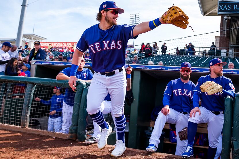 Texas Rangers infielder Patrick Wisdom takes the field for a spring training game against...