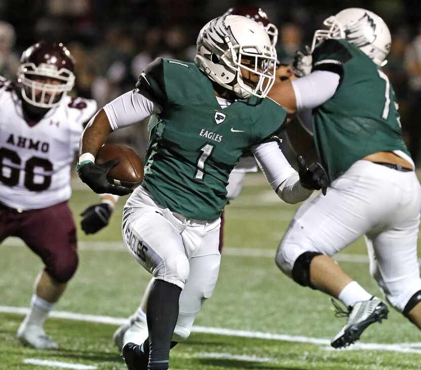 Prosper running back Robert Mahone (1) looks for room to run behind his offensive line...