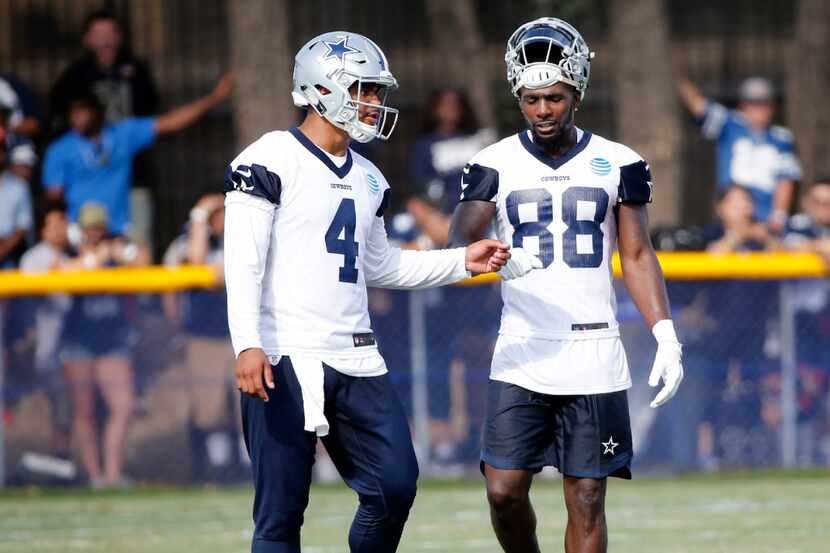 Dallas Cowboys quarterback Dak Prescott (4) talks to Dallas Cowboys wide receiver Dez Bryant...