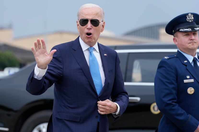 President Joe Biden waves as he walks to board Air Force One at Joint Base Andrews on June...