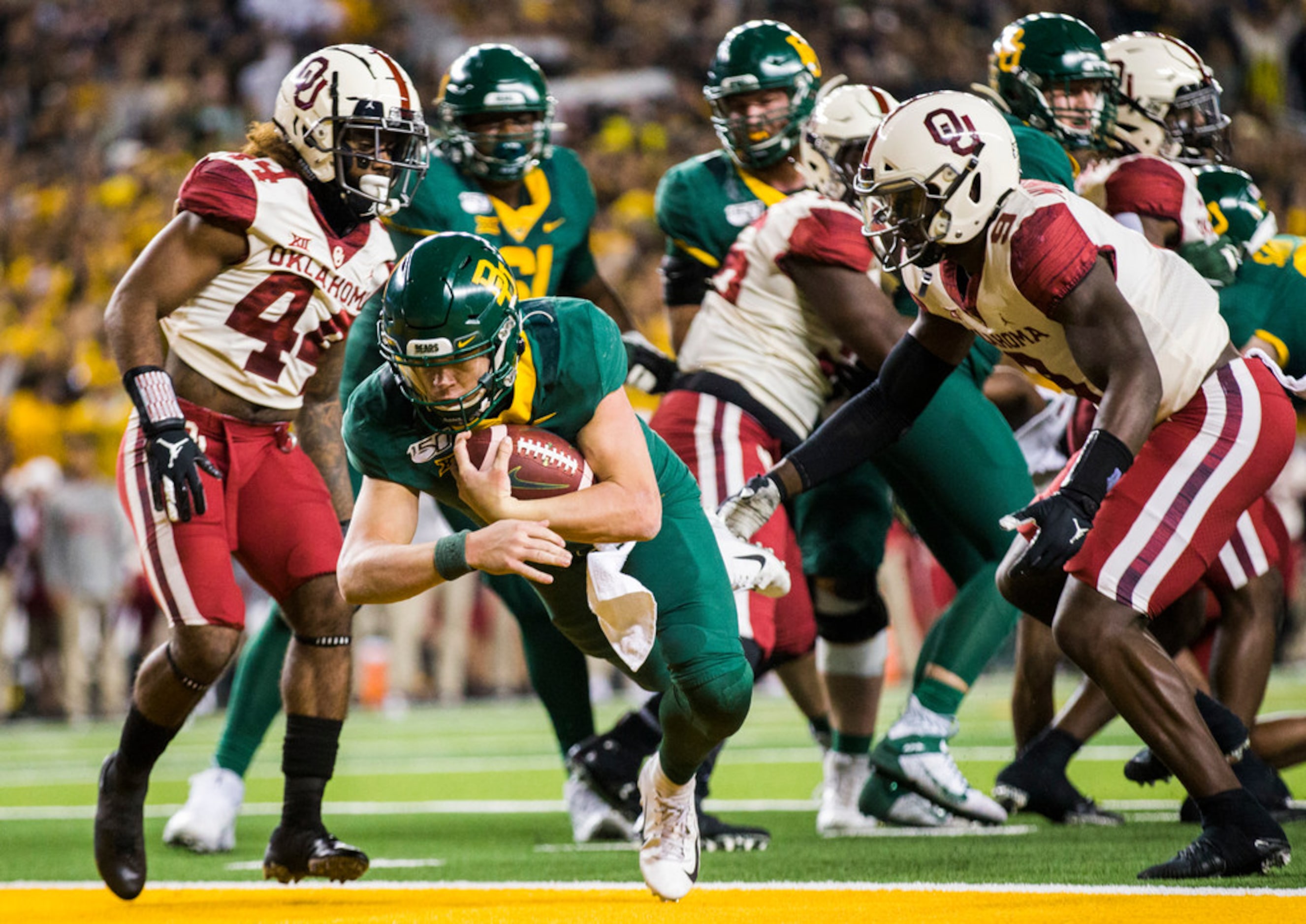 Baylor Bears quarterback Charlie Brewer (12) dives across the goal line for a touchdown...