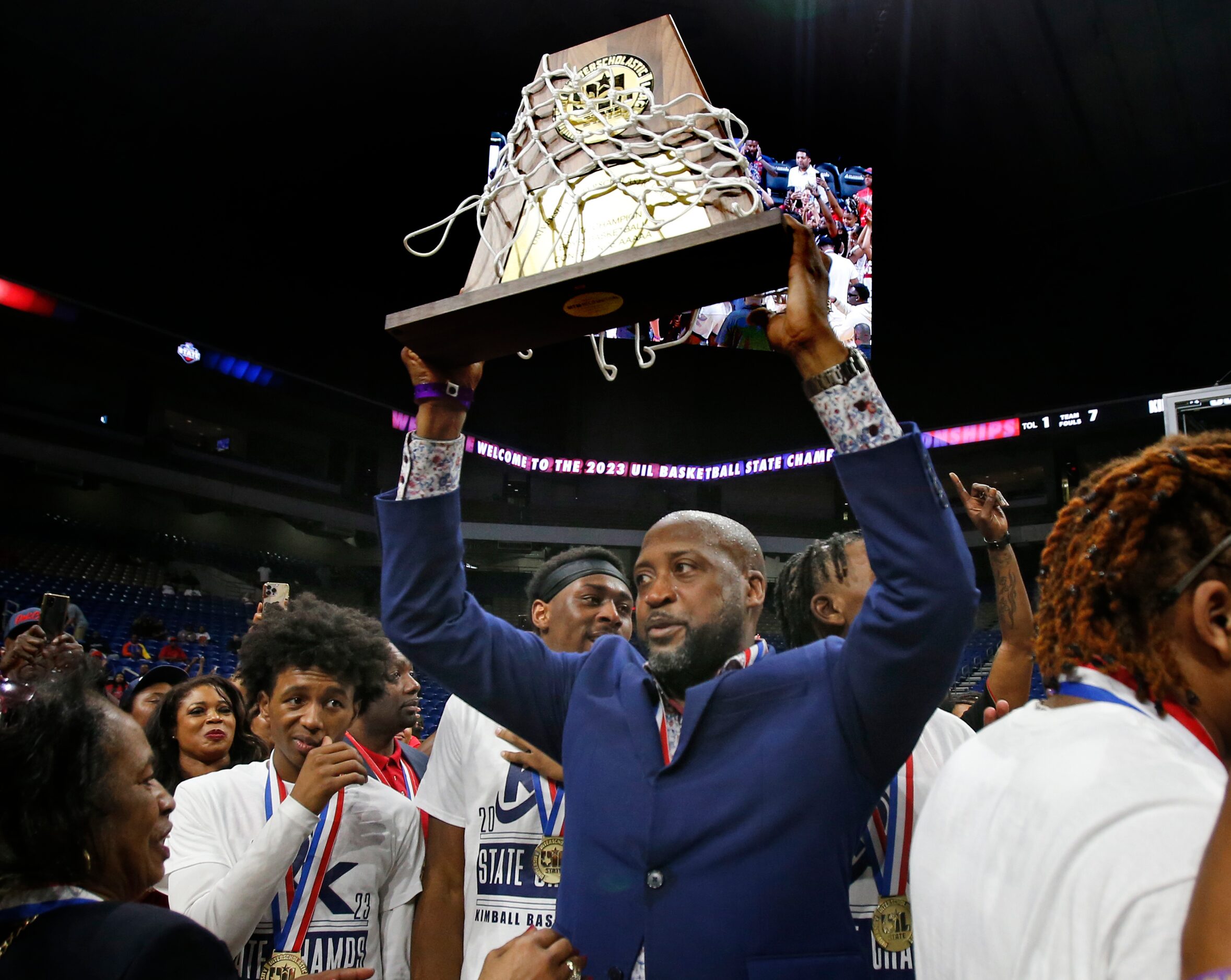 Dallas Kimball head coach Nicke Smith holds up the trophy for his team. Dallas Kimball...