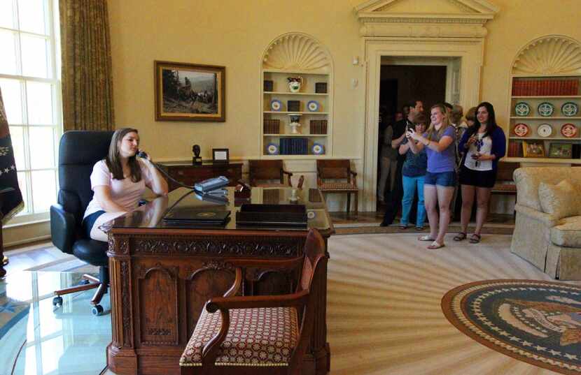 A replica of the Oval Office during the George W. Bush presidency provides a photo-op for...