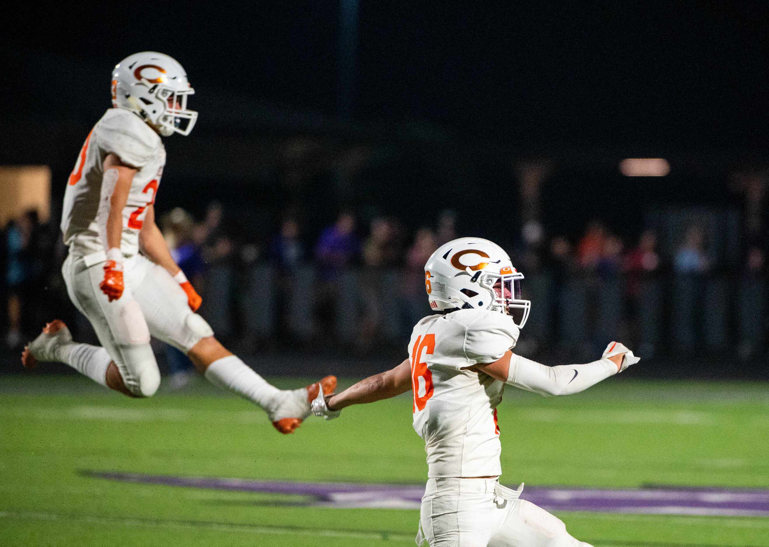 Celina’s Ben Thomas (23) and Dean Hamilton (16) celebrate after a turnover in the first half...